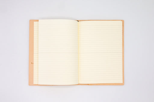 Double page spread of lined ivory page inside goat leather notebook