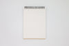 White lined paper inside Mnemosyne Note Pad with top spiral binding