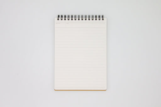 White lined paper inside Mnemosyne Note Pad with top spiral binding