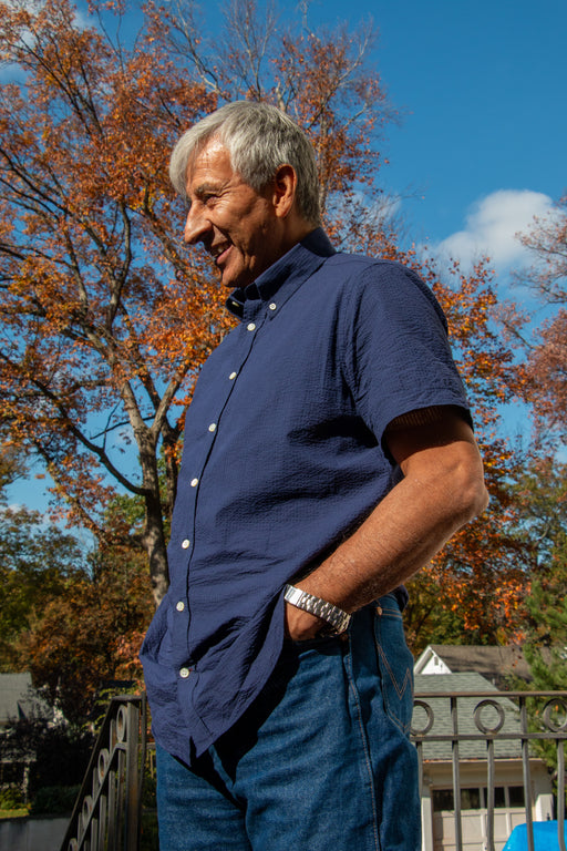 Model wearing blue short sleeve collar shirt with white buttons
