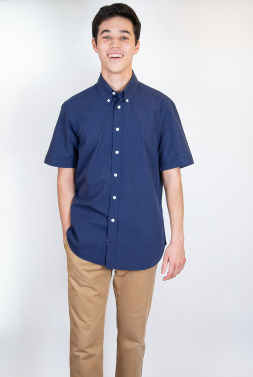 Model wearing blue short sleeve collar shirt with white buttons