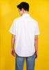 Back view of model wearing white short sleeve collar shirt and jeans