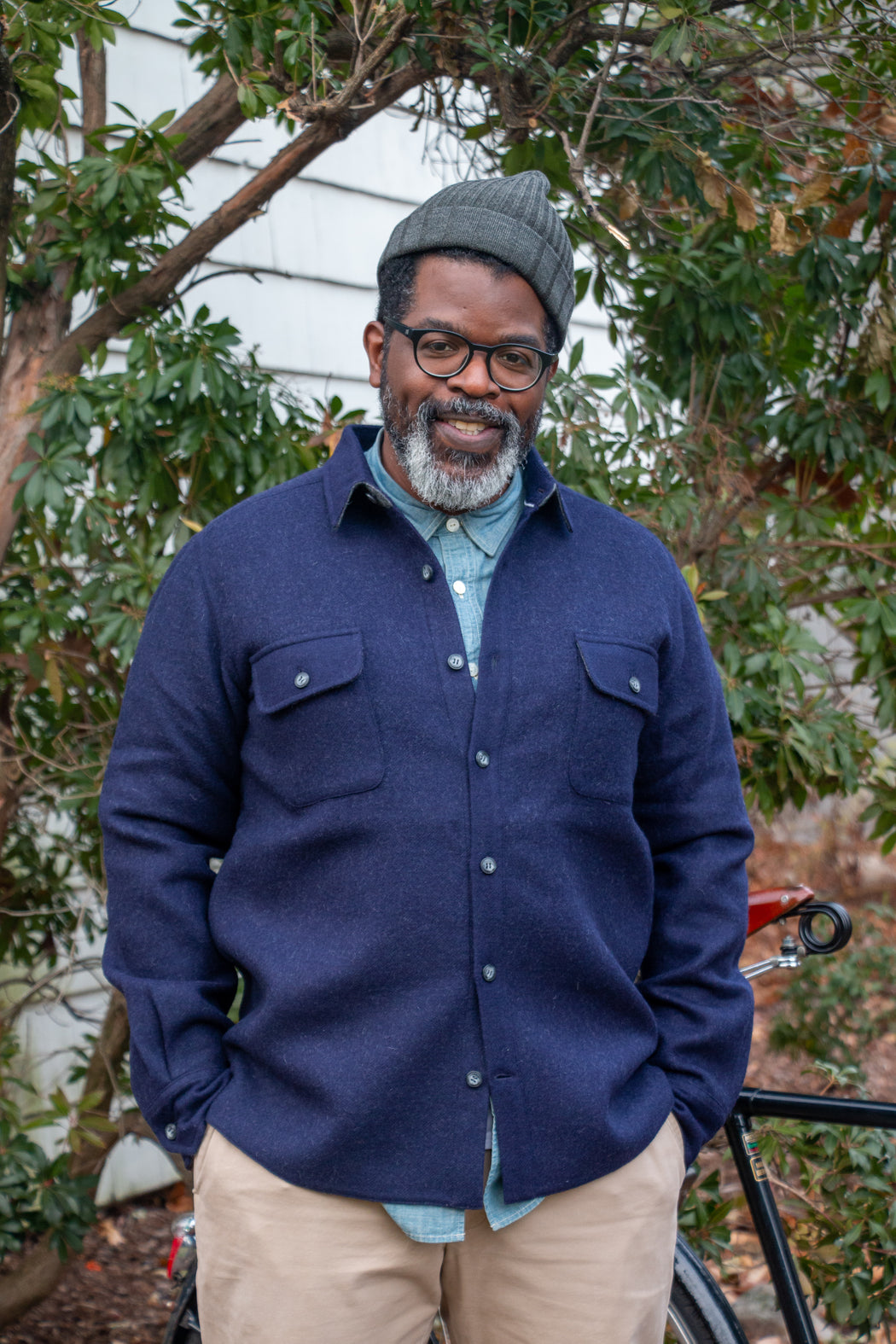 Man smiling wearing dark blue utilitarian CPO over shirt