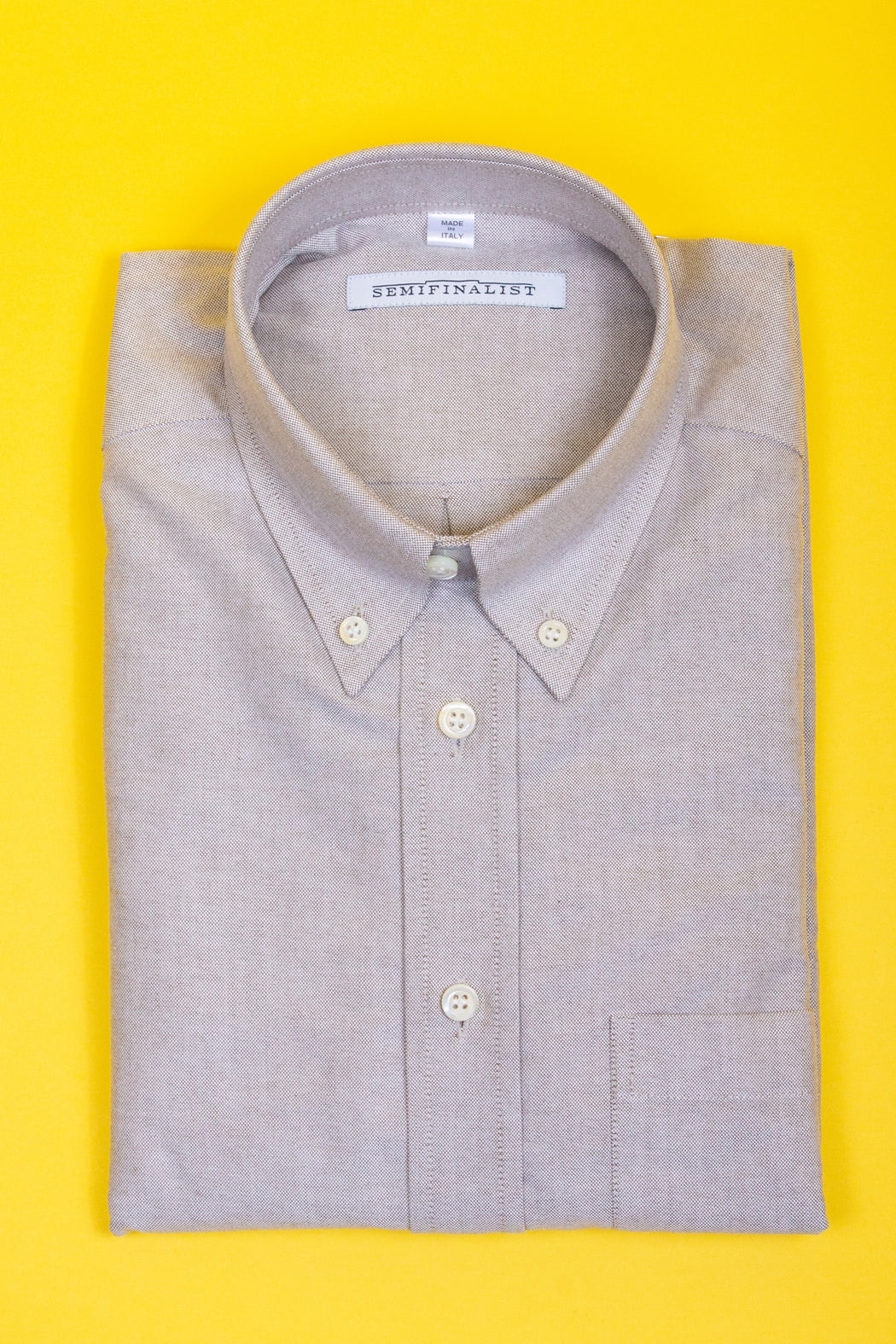 Sage colored button-down collar shirt, folded