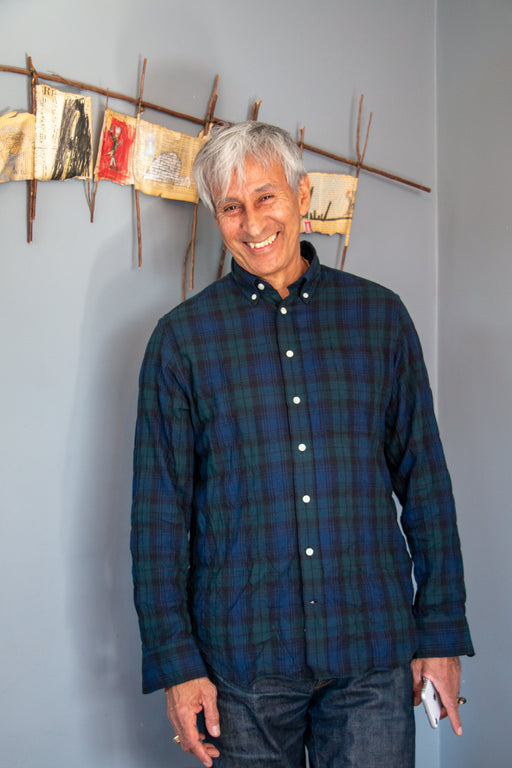 Model wearing blue & green plaid button down collar shirt with front pocket