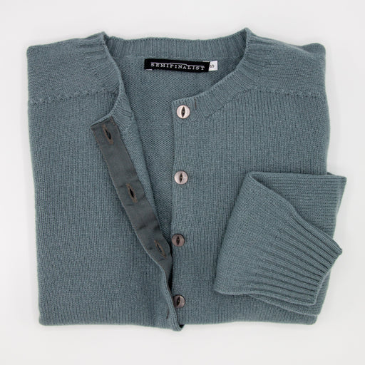 Grey-green cardigan sweater, folded
