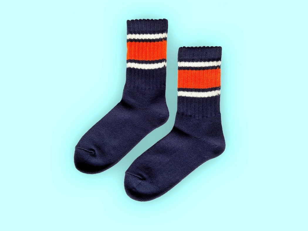 Navy tube socks with orange & white stripes