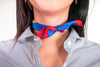 Smile text on dark blue Italian silk pocket square tied around girl's neck