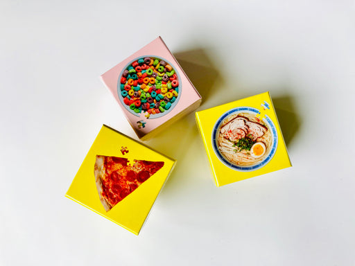 3 Little Food Puzzle boxes featuring an image of a slice of pizza, a bowl of cereal, and a bowl of ramen