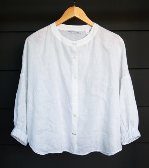 White button down shirt with long sleeves and a curved collar & hem