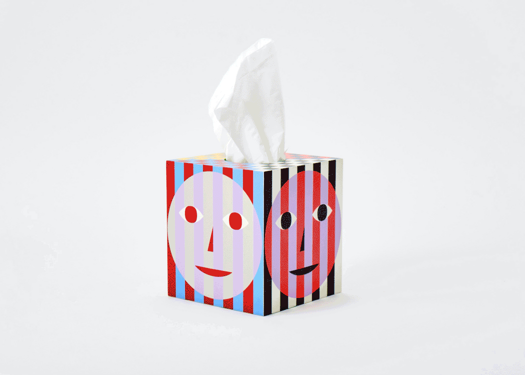 multi color stripe tissue box with face graphic, spinning to show all sides