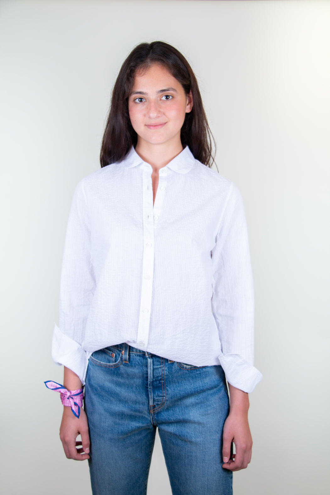 Model wearing white crinkle cotton button down shirt with Peter Pan collar