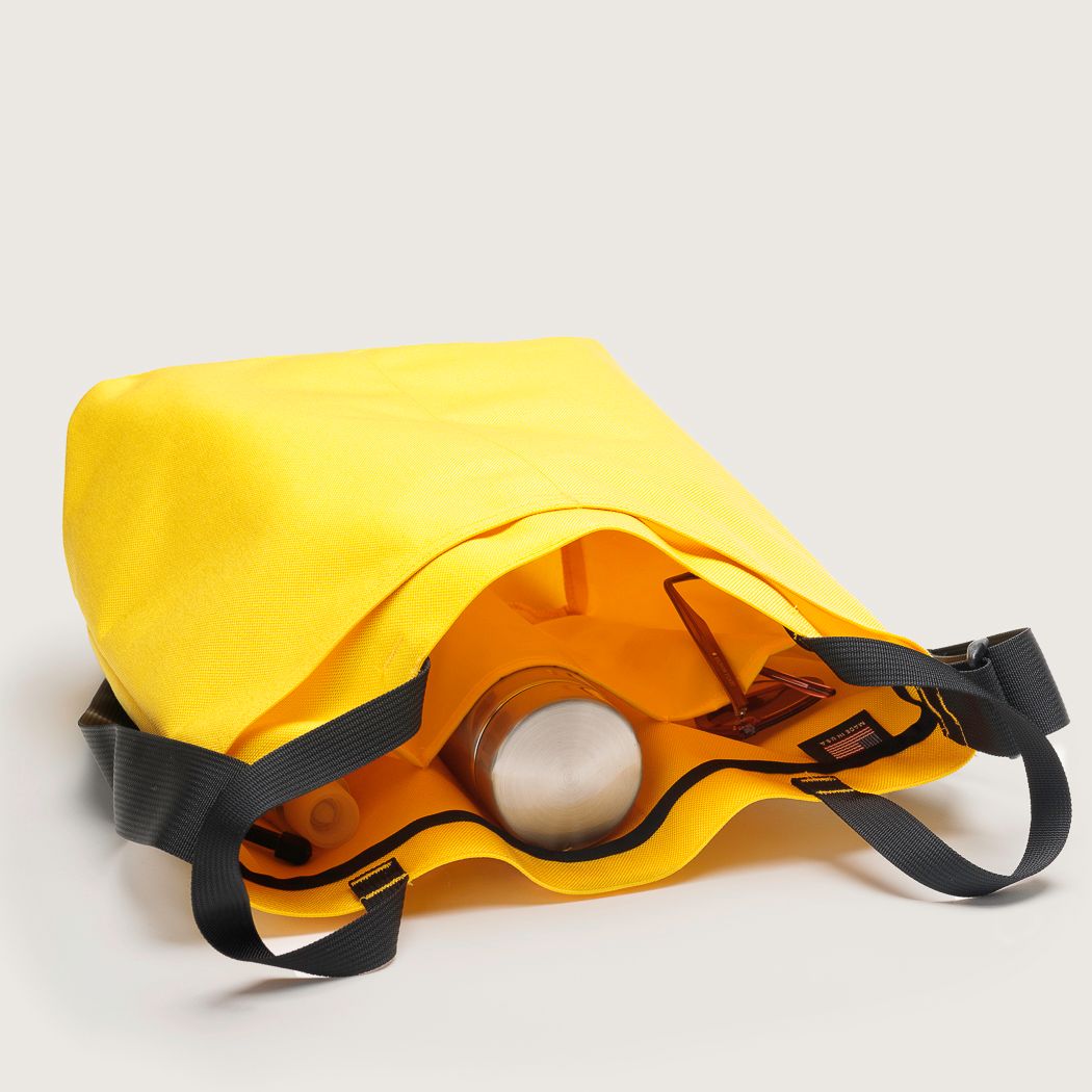 Interior pocket view of yellow Mid Side Handle Tote