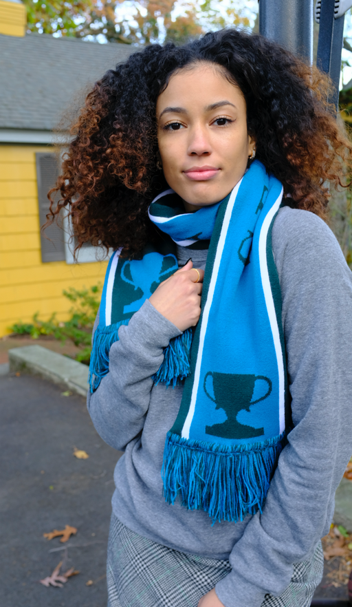 Female model wearing a blue & green Semifinalist soccer scarf around her neck