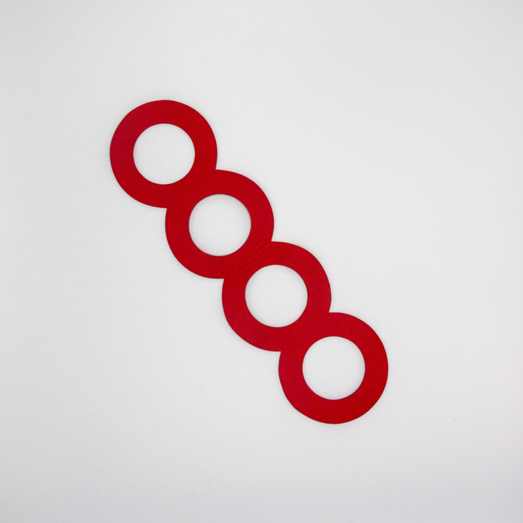 Red leather bracelet, stretched out in 4 ring shapes