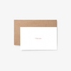 White note card reading "I love you." in front of tan envelope