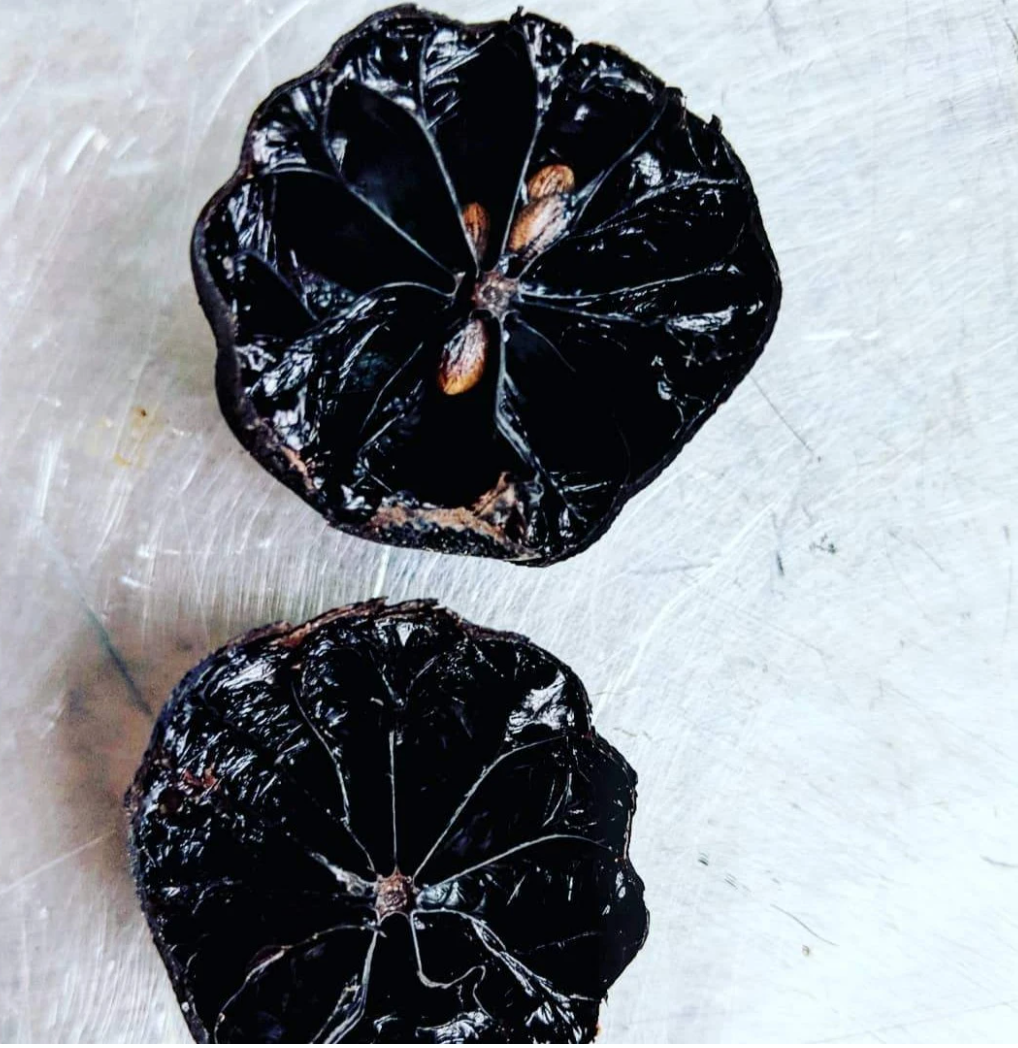The cross-section of a black lime, cut in half
