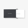 Stack of white business cards reading "Stop Talking" coming out of a black box  also reading "Stop Talking"