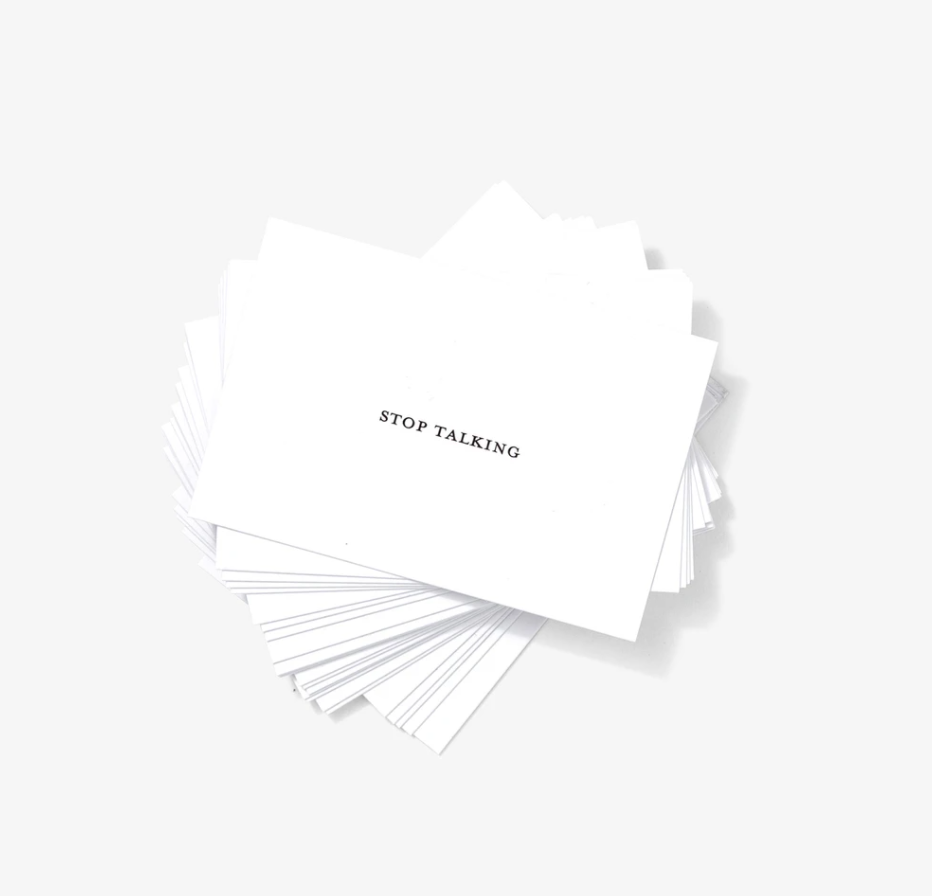 Fanned out stack of white business cards reading "Stop Talking"
