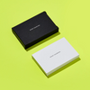 Stack of white business cards reading "Stop Talking" below a black box reading the same