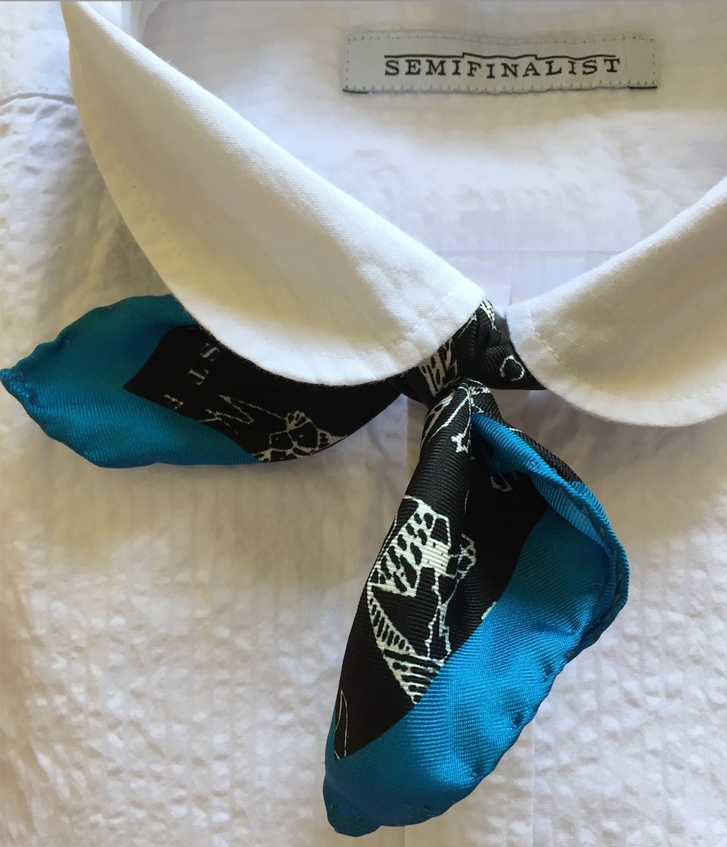Black & white silk pocket square scarf with blue border, tied around Semifinalist blouse collar
