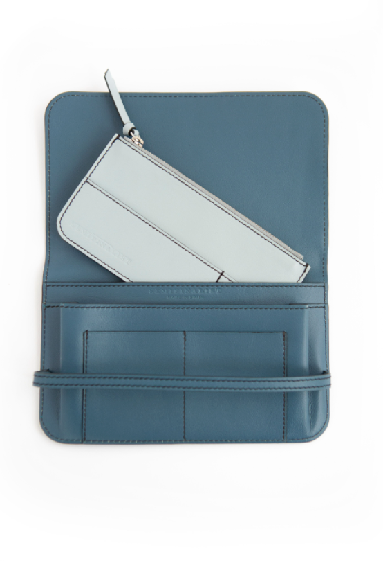 Blue leather wallet clutch with horizontal strap and light blue interior card holder