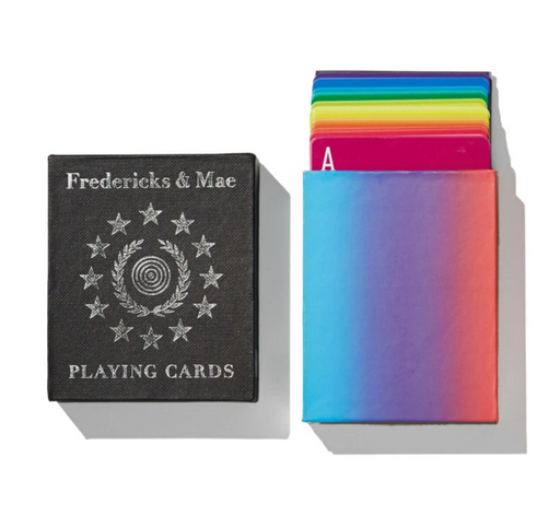 Rainbow colored playing cards sticking out of cardboard box, next to black "Playing Cards" brochure