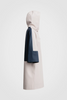 Side view: White hooded raincoat with navy back panel and  sleeves