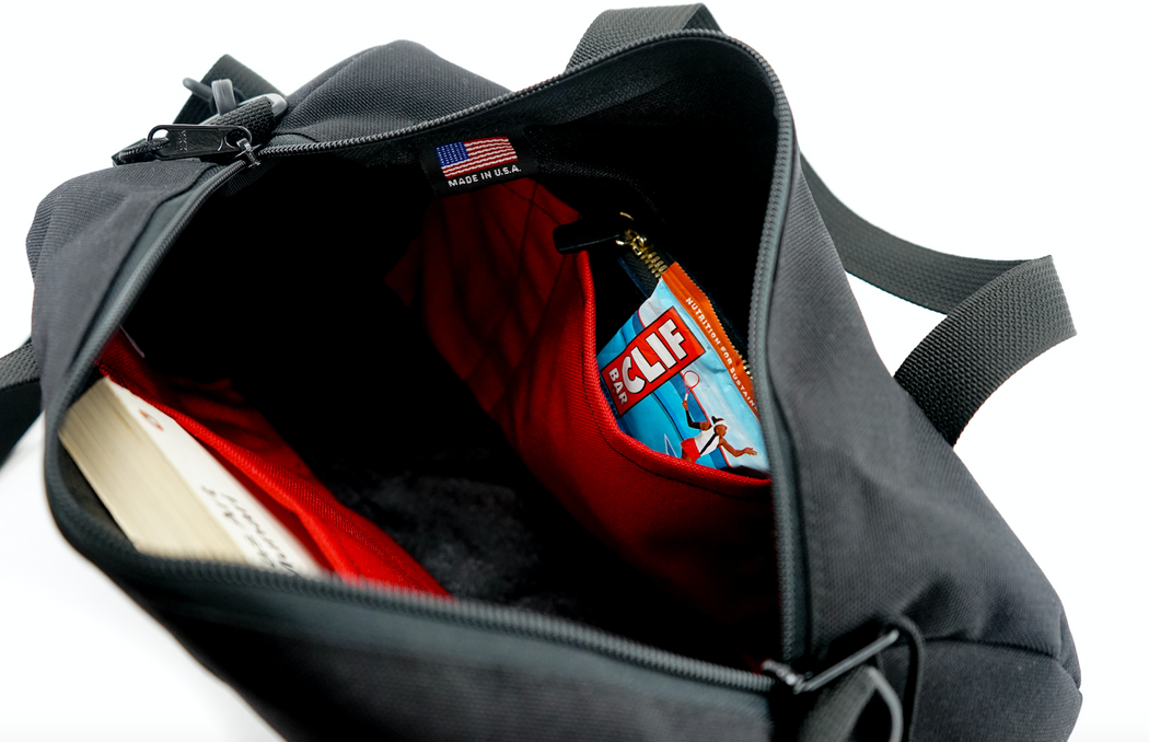 Interior view:  Black canvas duffle bag with 2 interior red pockets