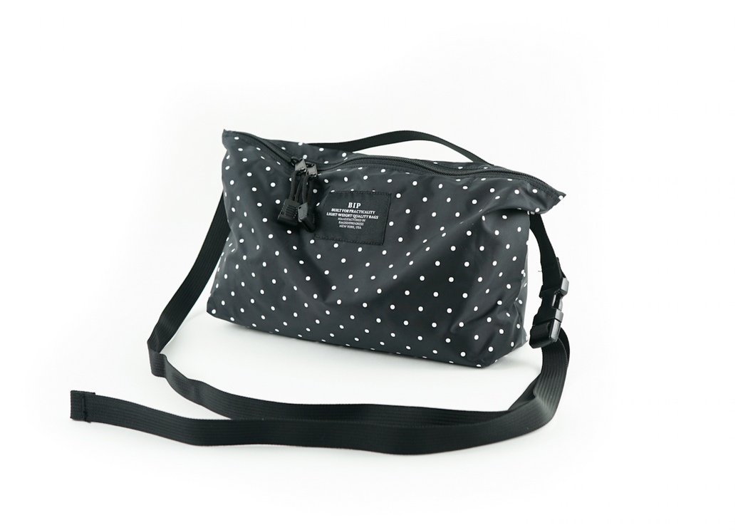Black and white dot nylon fanny pack with zip closure and adjustable black strap