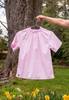 Short sleeve pink shirt with ruched neckline on hanger