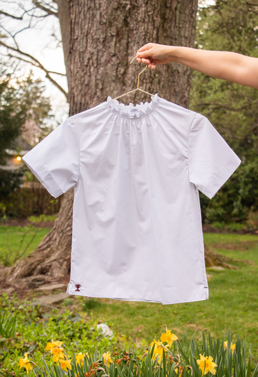 Short sleeve light grey shirt with ruched neckline on hanger