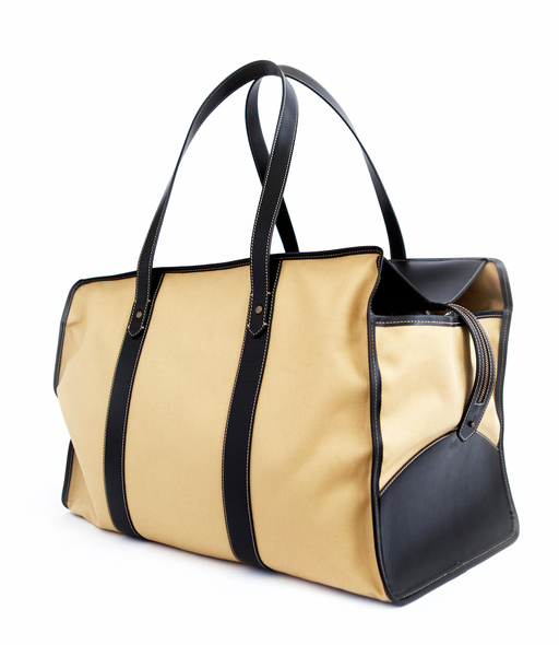 Tan fabric travel bag with black leather straps and trim