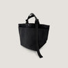 Two pockets on back of black canvas tote with adjustable handle straps