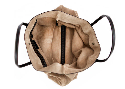 Interior top view of tan suede slouchy tote with black leather trim and handles